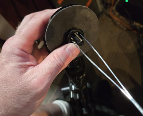 using tweezers to loosen the nut